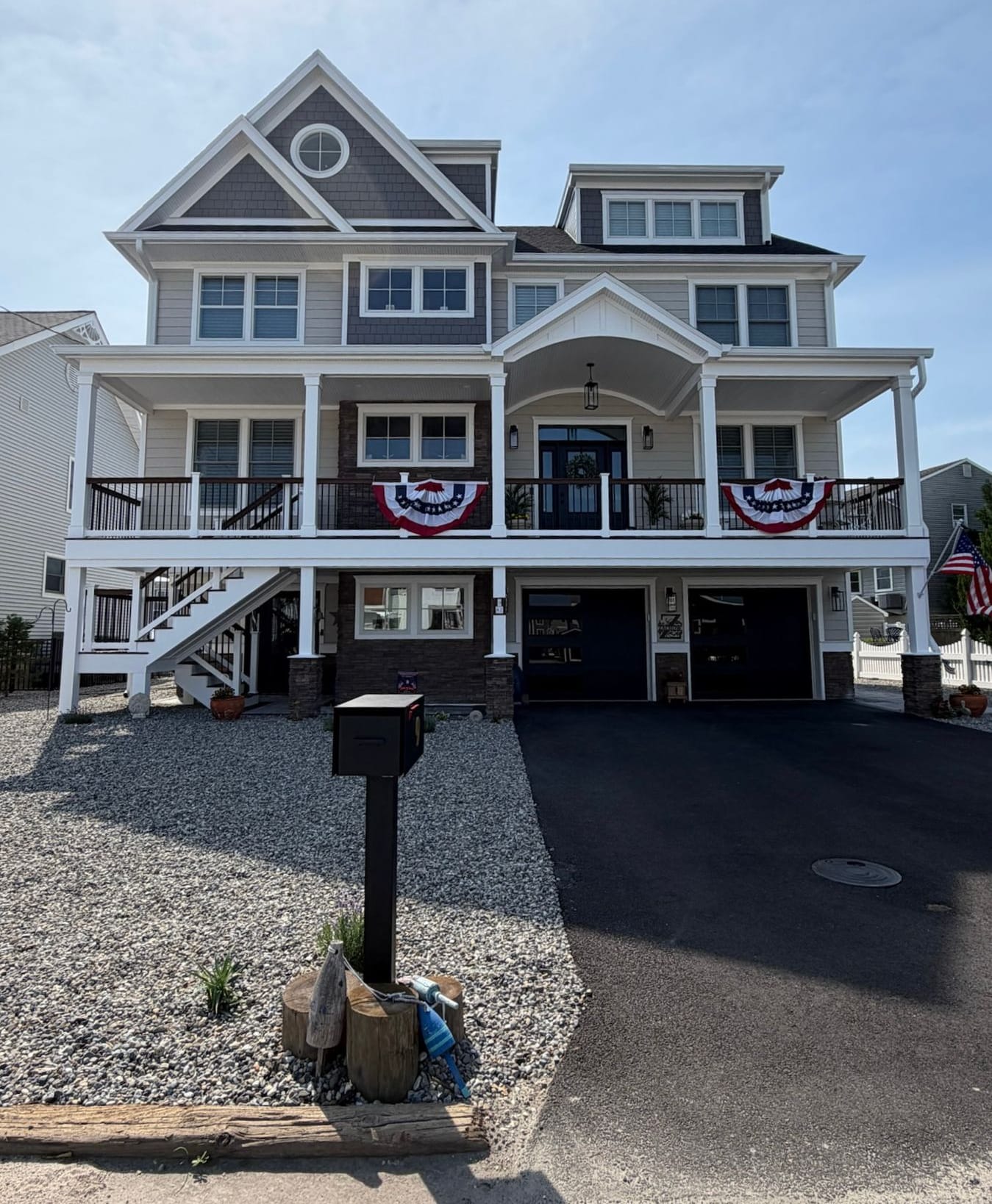 Three-story coastal custom home with wraparound porches, built by ERS Better Homes on the Jersey Shore